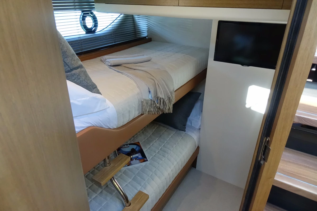 2016 Princess V58 Open yacht cabin with bunk beds and TV.