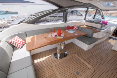 Luxurious 2016 Princess V58 Open yacht interior with elegant seating and wooden table.