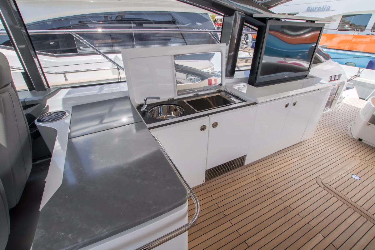 Luxurious 2016 Princess V58 Open yacht interior with sleek kitchen and modern amenities.
