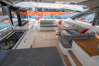 Luxurious 2016 Princess V58 Open yacht interior with elegant seating and dining area.