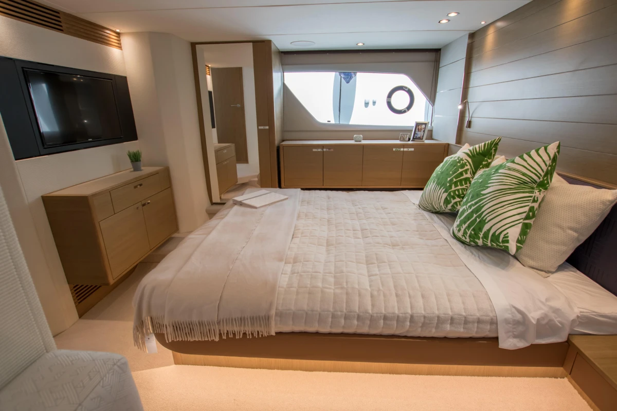 Luxurious bedroom interior of 2016 Princess V58 Open yacht with modern decor and large bed.