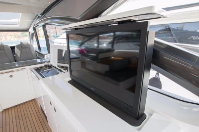 Luxurious interior of 2016 Princess V58 Open yacht with modern TV and seating area.