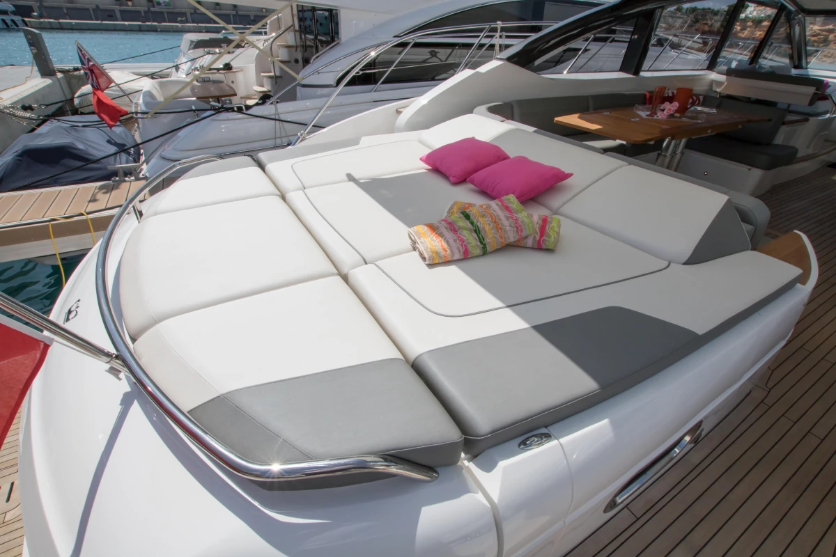 Luxurious 2016 Princess V58 Open yacht with sunbathing area and colorful cushions.