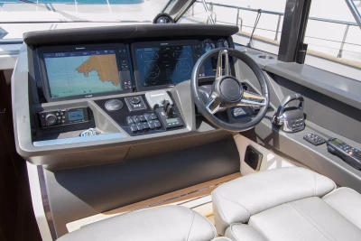 Helm of 2016 Princess V58 Open yacht with navigation screens and controls.