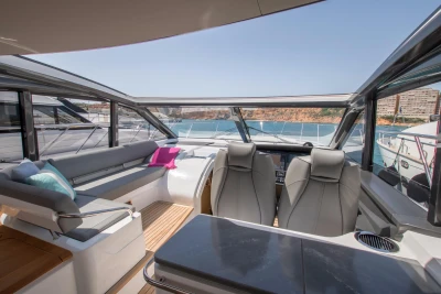 2016 Princess V58 Open yacht interior with seating, helm, and ocean view.