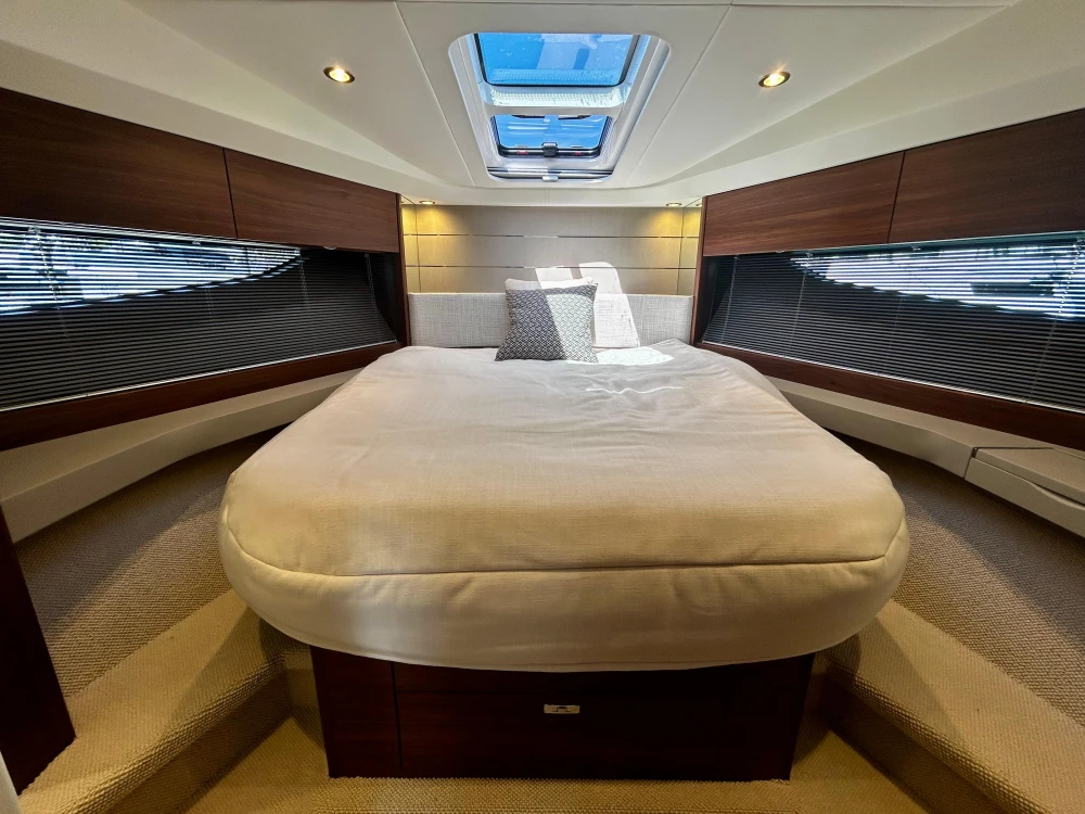 Luxurious 2024 Princess V40 yacht cabin with elegant bedding and modern design.