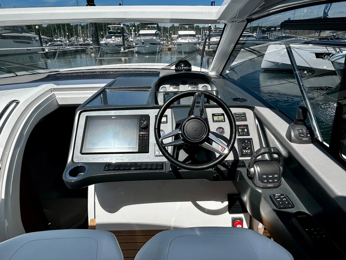 2024 Princess V40 yacht cockpit with modern navigation controls and steering wheel.
