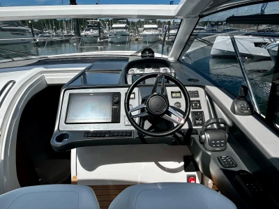 2024 Princess V40 yacht cockpit with modern navigation controls and steering wheel.