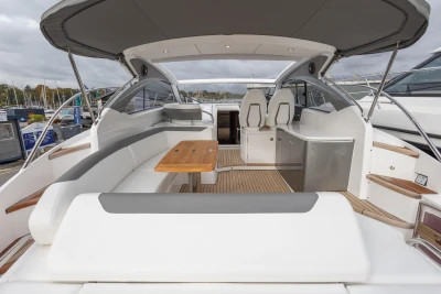 2024 Princess V40 yacht interior with elegant seating and wooden table.