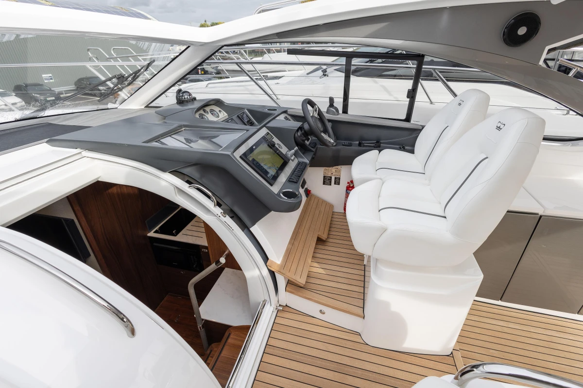 2024 Princess V40 yacht cockpit with modern controls and luxurious white seating.