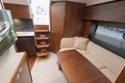Luxurious interior of 2024 Princess V40 yacht with elegant wood finishes and cozy seating area.