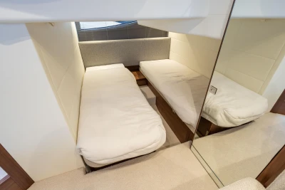 2024 Princess V40 yacht cabin with twin beds and modern decor.