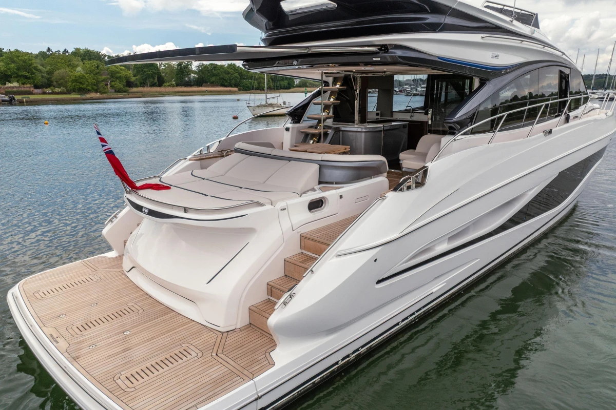 Luxurious 2025 Princess S65 yacht with sleek design, docked on calm waters.