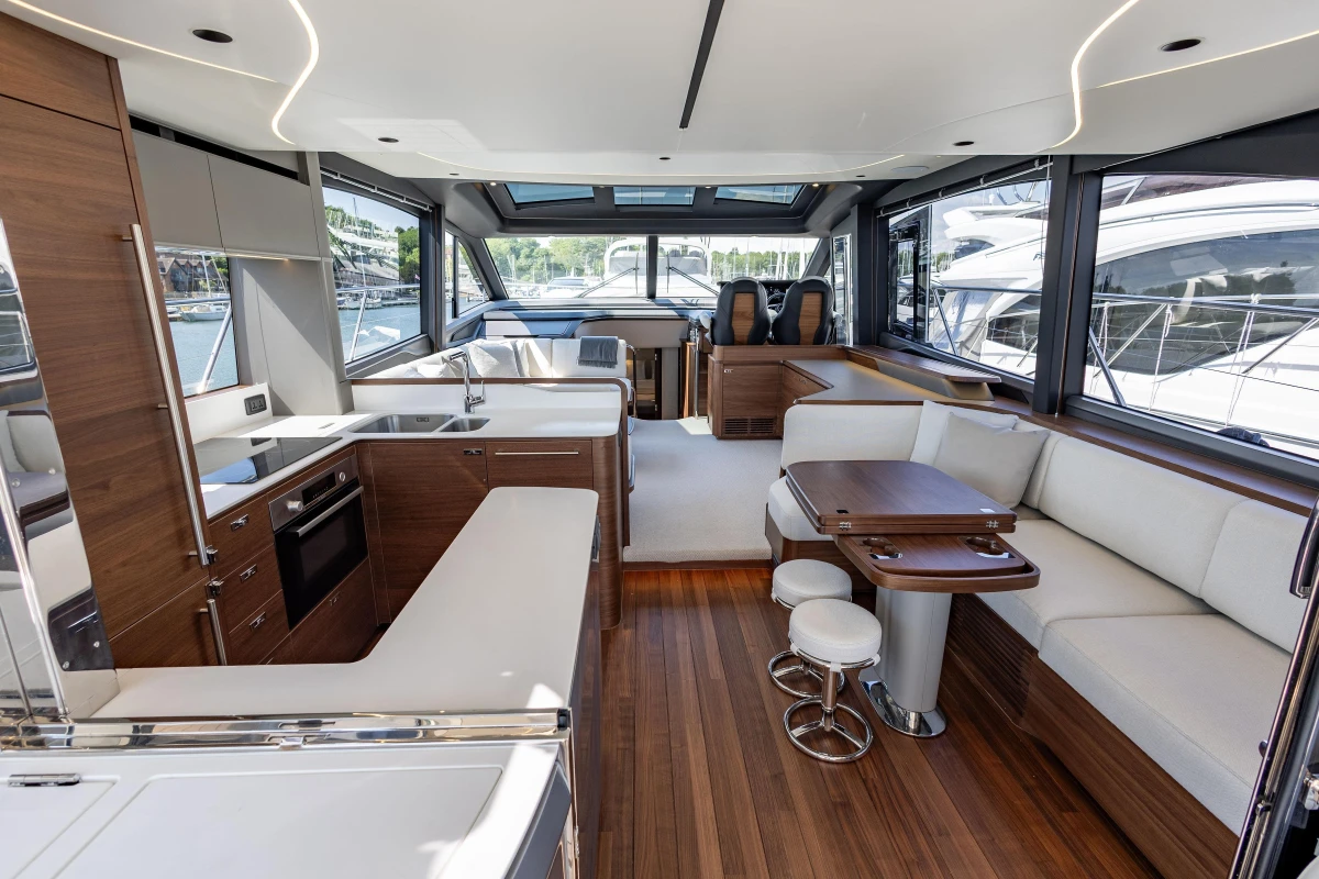 Luxurious interior of 2025 Princess S65 yacht with modern kitchen and seating area.