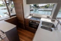 Modern kitchen interior on 2025 Princess S65 yacht, featuring sleek design and waterfront view.
