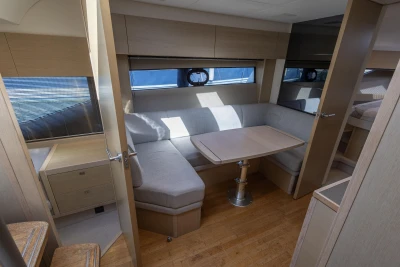 Luxurious interior of 2018 Princess V40 yacht with cozy seating and wooden finishes.