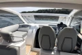 2022 Princess V40 yacht interior with modern seating and steering, overlooking scenic water view.