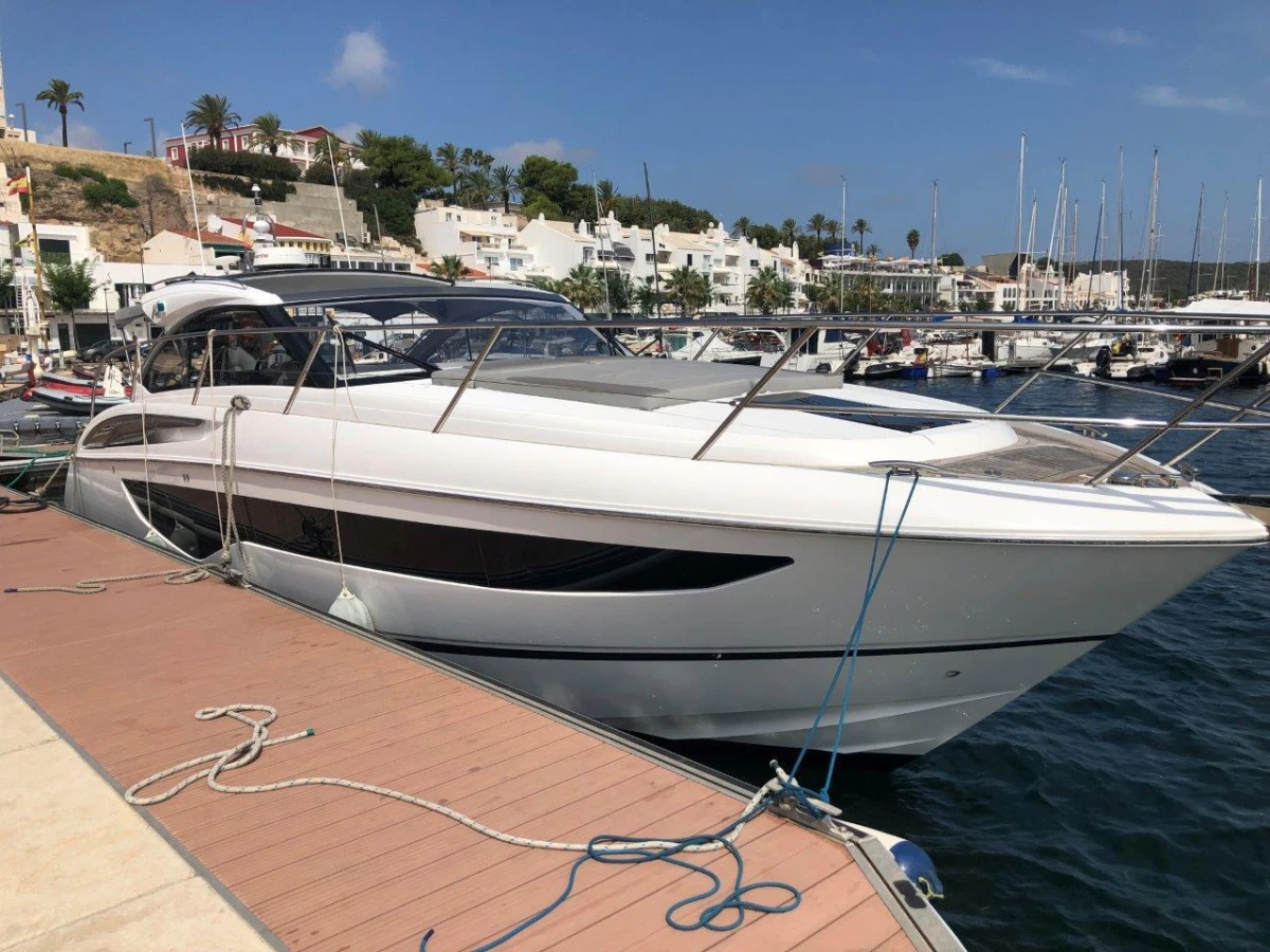 2022 Princess V40 yacht docked at a marina, clear sky, waterfront view.