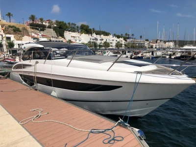 2022 Princess V40 yacht docked at a marina, clear sky, waterfront view.