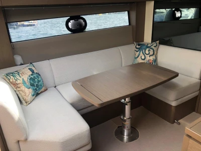 Luxurious 2022 Princess V40 yacht interior with elegant seating and decorative pillows.