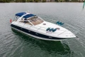 2000 Princess V42 yacht on water, featuring sleek design and blue canopy.