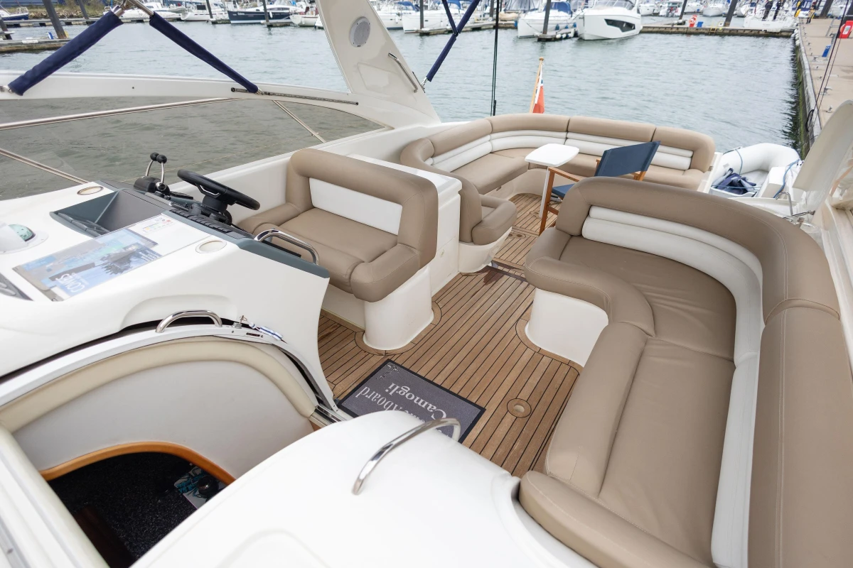 Luxurious 2000 Princess V42 yacht interior with elegant seating and wooden flooring.