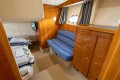 Luxurious interior of 2000 Princess V42 yacht with cozy seating and elegant wood finishes.