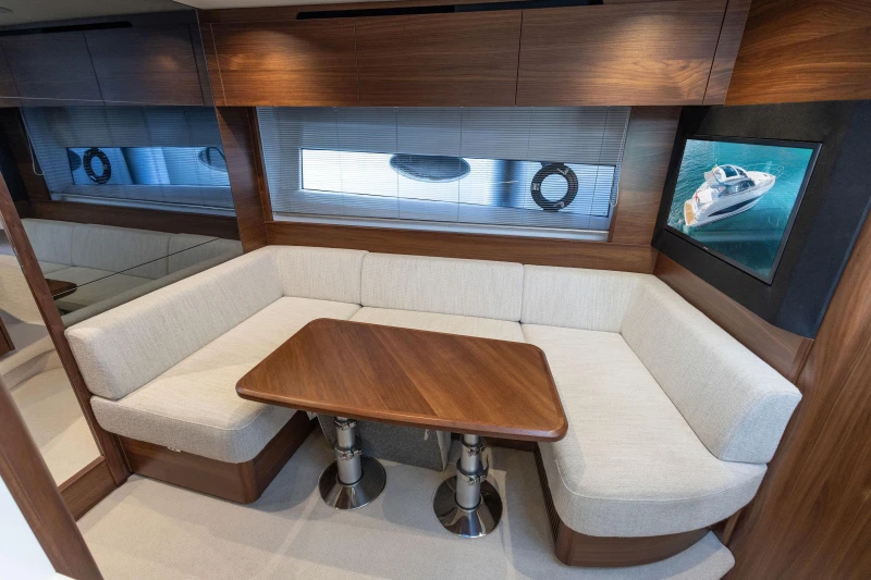 Luxurious interior of 2024 Princess V50 Open yacht with elegant seating and wooden table.