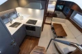 Luxurious 2024 Princess V50 Open yacht interior with modern kitchen and cozy seating area.