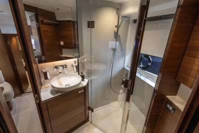 Luxurious bathroom interior of 2024 Princess V50 Open yacht, featuring modern fixtures and wood accents.