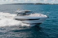 2024 Princess V50 Open yacht cruising on open sea under clear skies.