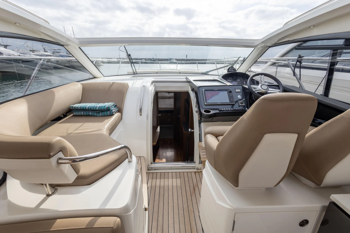 Interior of 2014 Princess V39 yacht with helm and seating area.