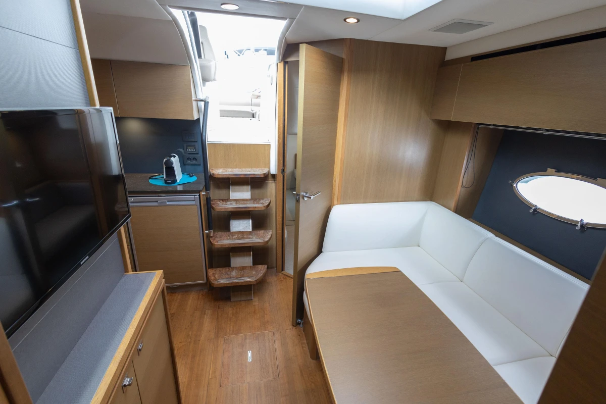 Luxurious interior of 2014 Princess V39 yacht with modern furnishings and wooden accents.