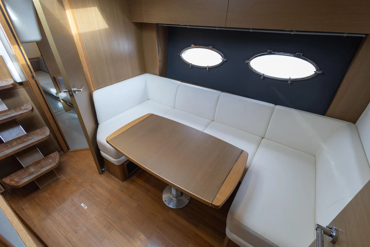 Luxurious interior of 2014 Princess V39 yacht with elegant seating and wooden table.