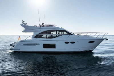 Luxury 2017 Princess 49 yacht cruising on calm ocean waters.