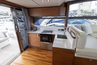 Luxurious interior of 2017 Princess 49 yacht with modern kitchen and seating area.