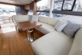 Luxurious interior of 2017 Princess 49 yacht with elegant seating and wooden table.