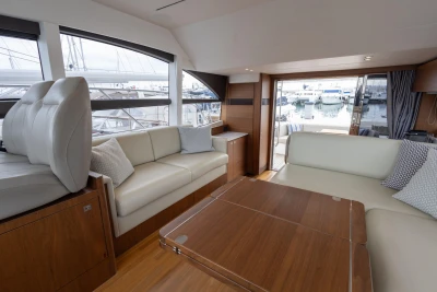 Luxurious interior of 2017 Princess 49 yacht with elegant seating and marina view.