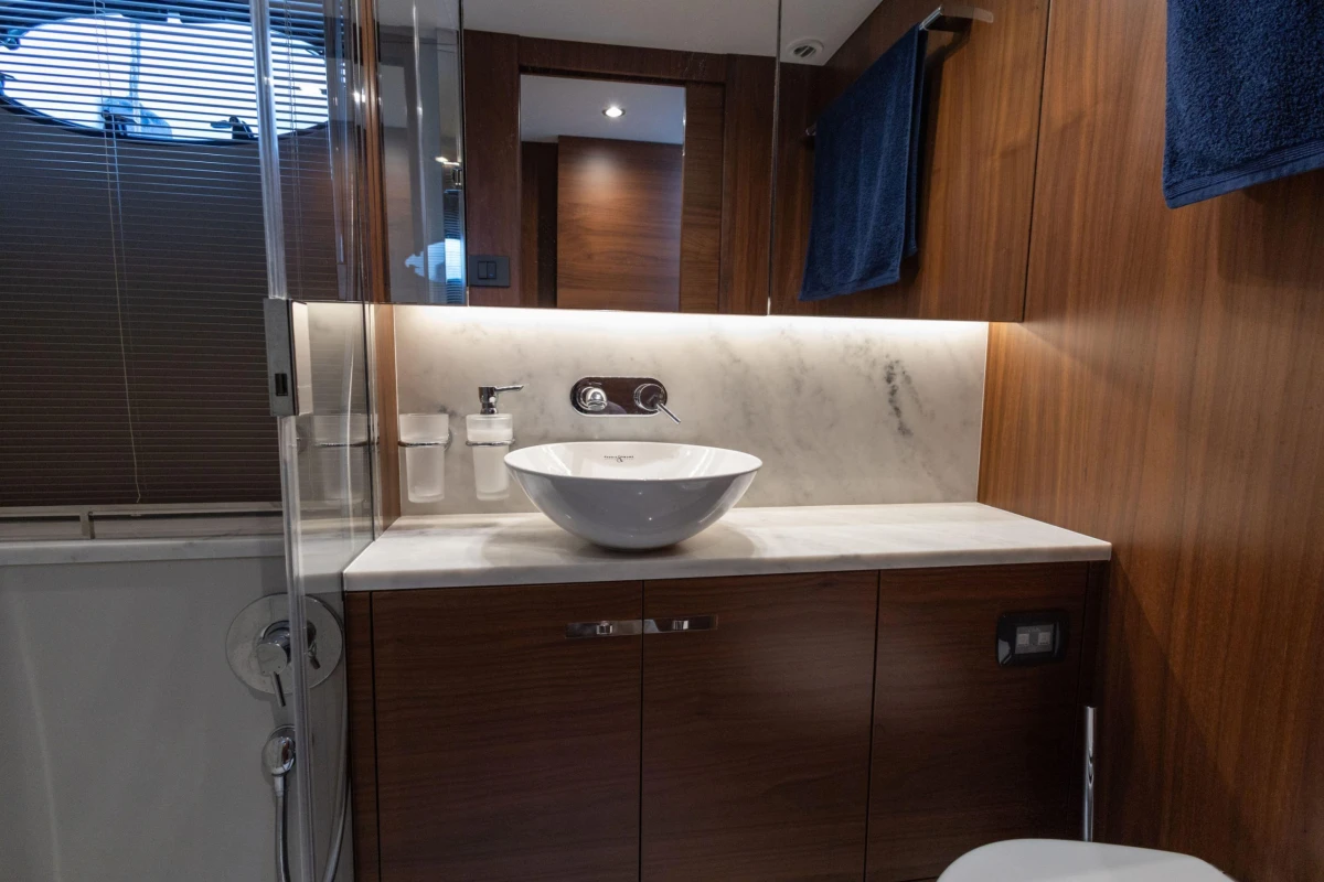 Luxurious bathroom in 2017 Princess 49 yacht with modern sink and wooden cabinetry.