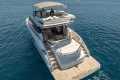 2023 Princess S62 yacht cruising on clear blue ocean waters.