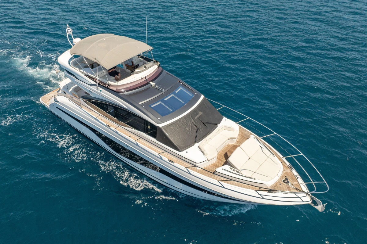 Luxurious 2023 Princess S62 yacht cruising on clear blue ocean waters.