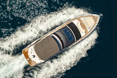 2023 Princess S62 yacht cruising on open water, aerial view.