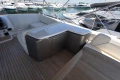 Luxurious 2023 Princess S62 yacht deck with seating and storage, docked at marina.