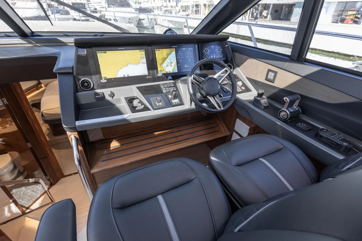 Helm of 2023 Princess S62 yacht with modern navigation displays and controls.