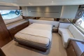 Luxurious 2023 Princess S62 yacht bedroom with elegant furnishings and large windows.