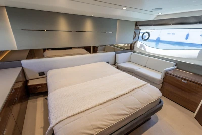 Luxurious bedroom interior of 2023 Princess S62 yacht with modern design and elegant furnishings.