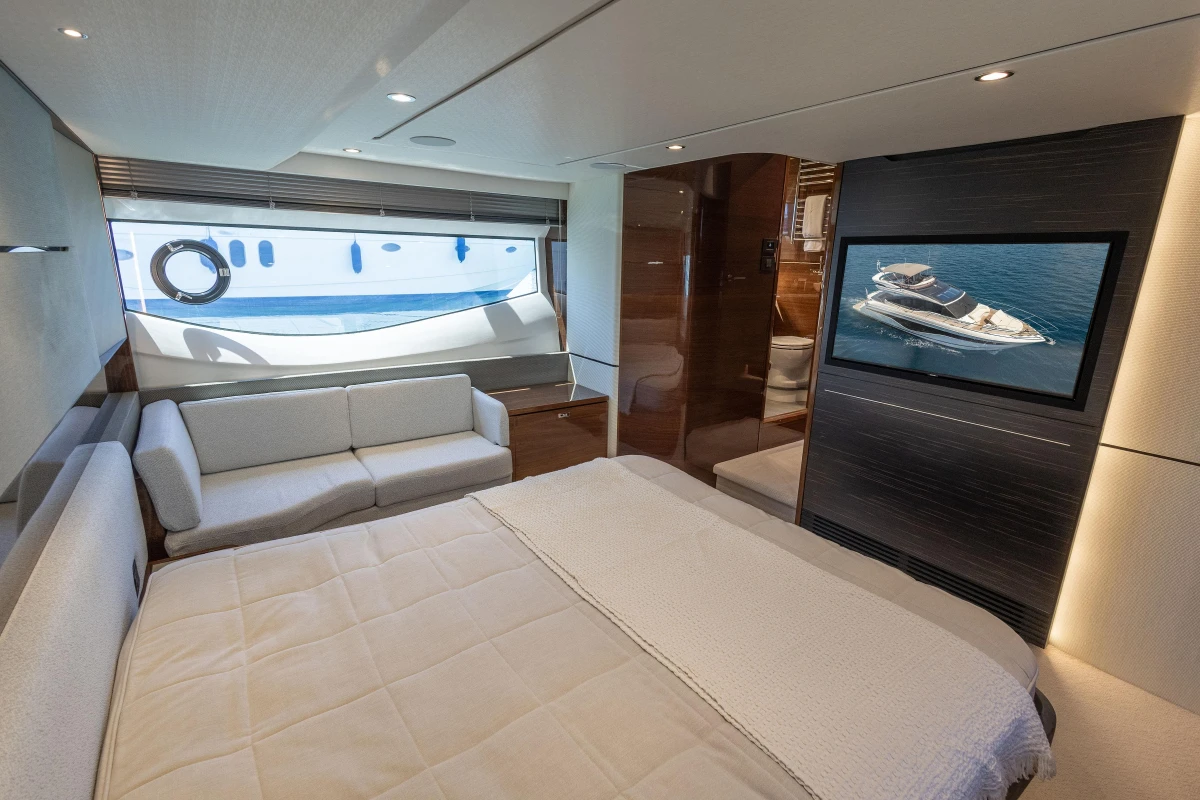 Luxurious interior of 2023 Princess S62 yacht with elegant bedroom and ocean view.