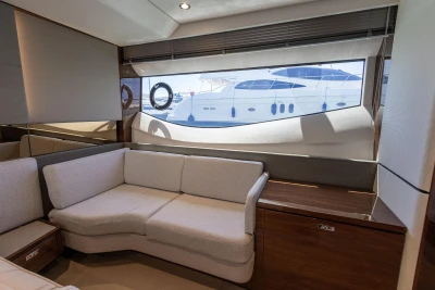 Luxurious interior of 2023 Princess S62 yacht with elegant seating and large window view.