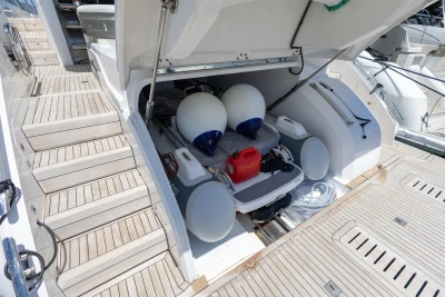 2023 Princess S62 yacht storage compartment with fenders and equipment on teak deck.