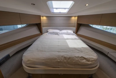 Luxurious bedroom interior of 2019 Princess V40 yacht with skylight and modern design.